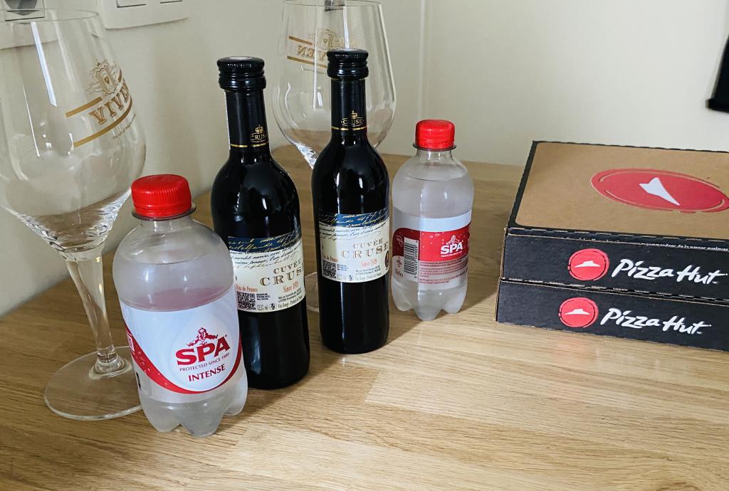 Photo of wine and Pizza Hut boxes