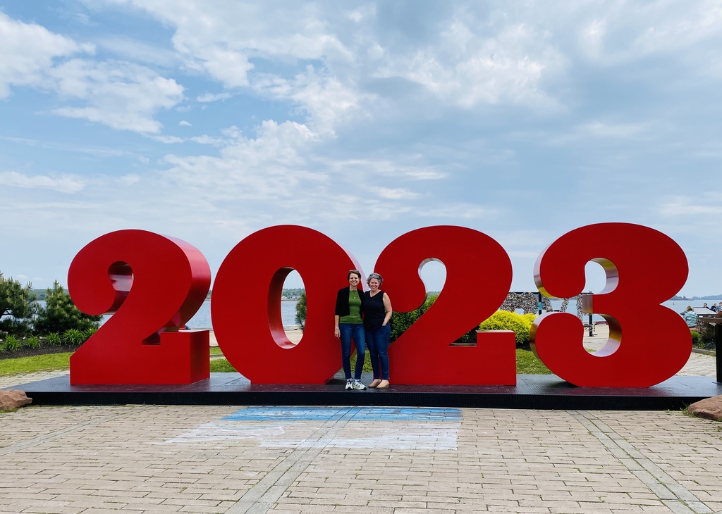 Andrea and I standing in front of a large metal 2023 sculpture on the Charlottetown waterfront.